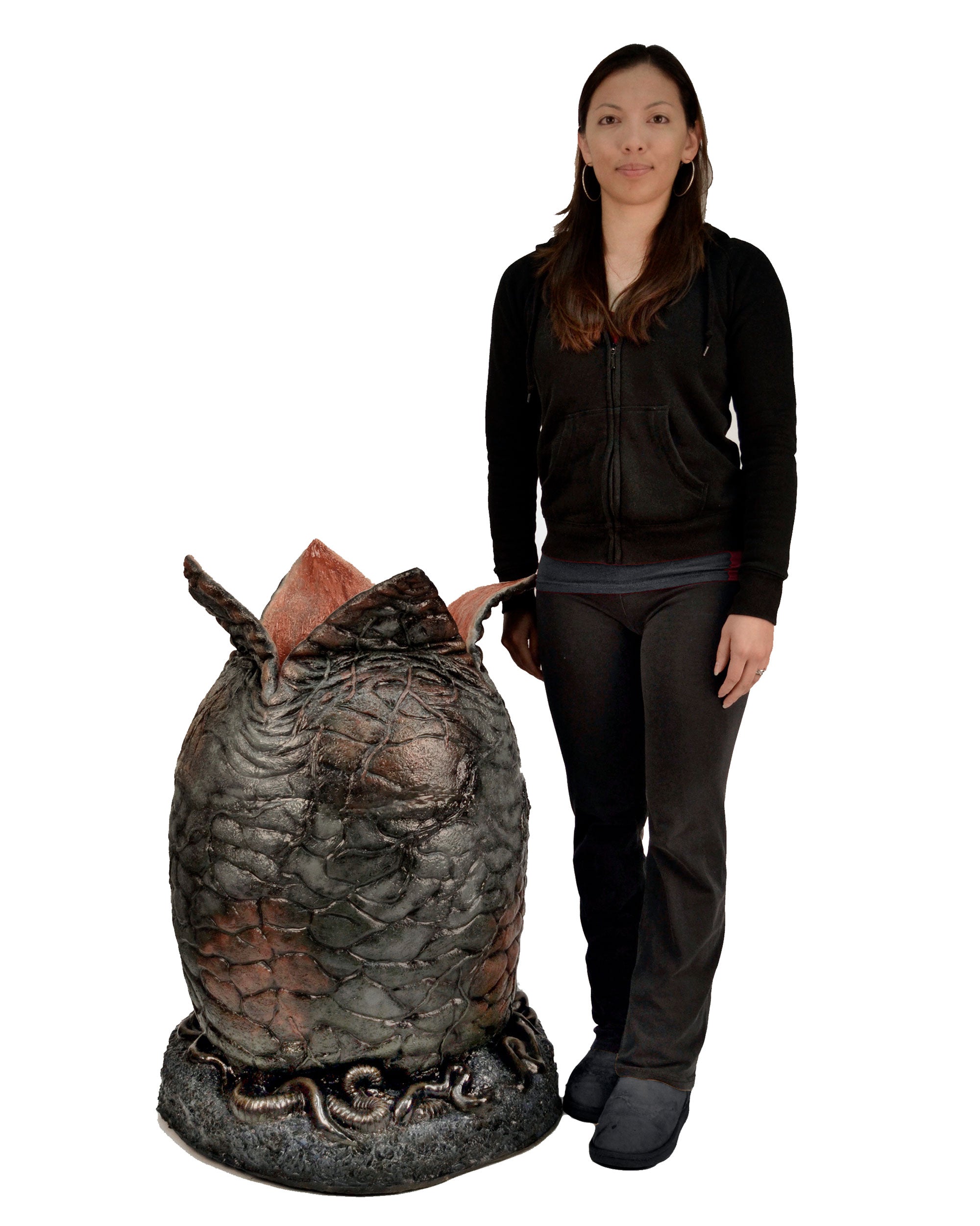 Woman standing next to life-size alien Xenomorph egg