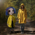 Coraline with Button Eyes Life-Size Plush Doll  next to person wearing raincoat